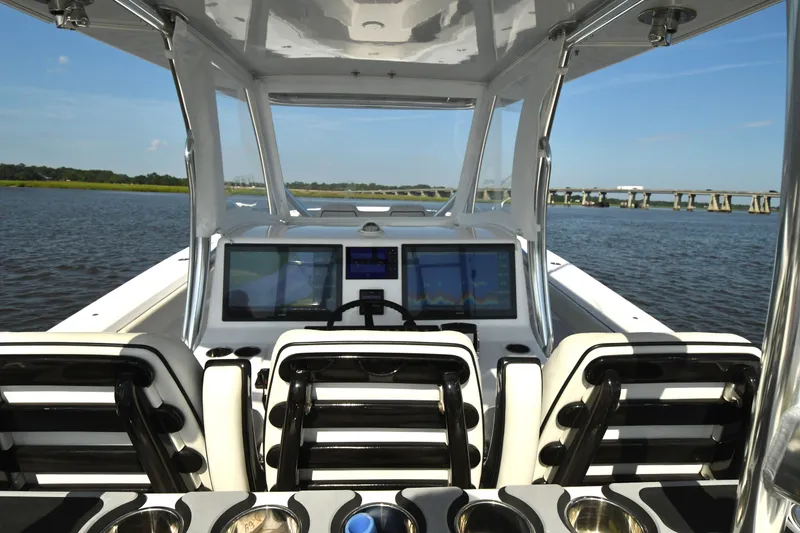 Slide: The Image of 2022 Front Runner 39 Center Console boat interior with advanced navigation screens on a sunny day. - 22