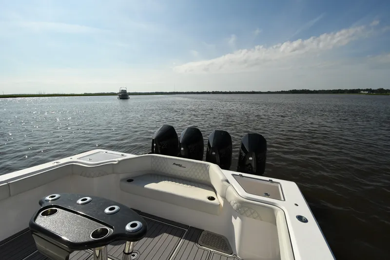 Slide: The Image of 2022 Front Runner 39 Center Console boat on calm water, featuring multiple outboard engines. - 23