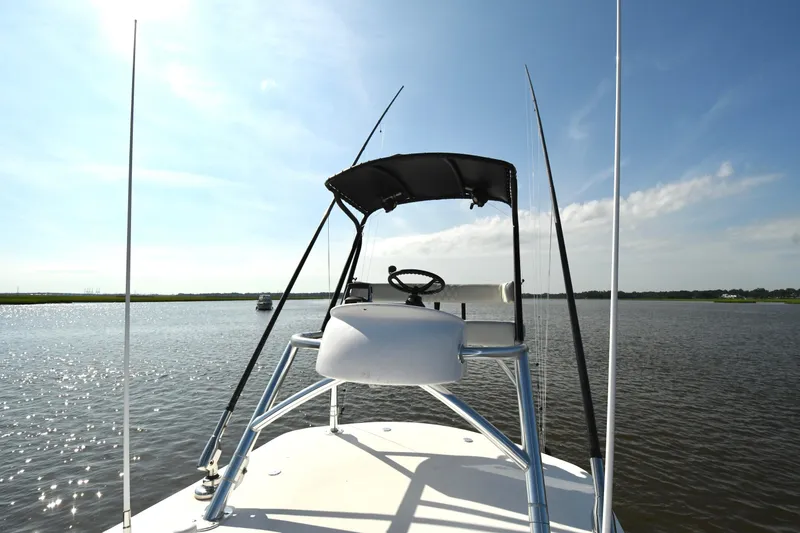 Slide: The Image of 2022 Front Runner 39 Center Console boat on calm water under clear blue sky. - 24