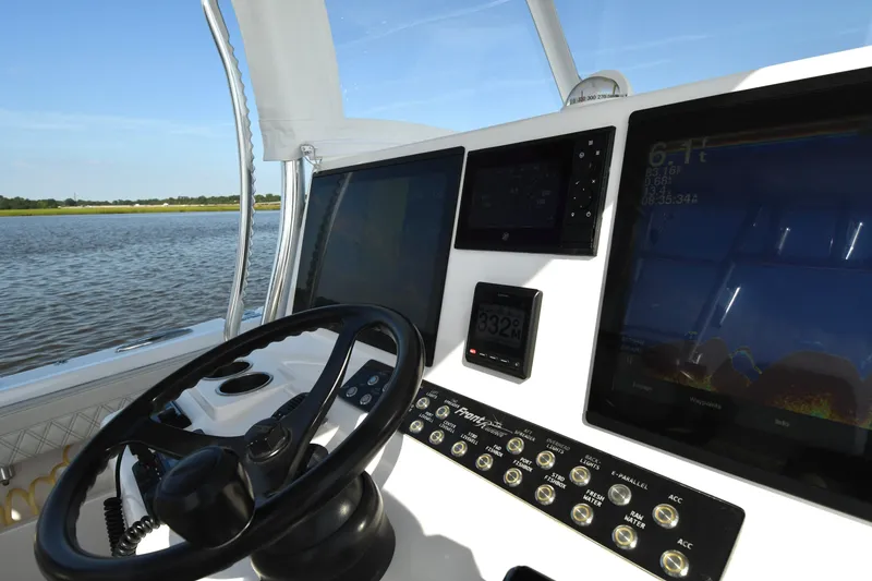 Slide: The Image of 2022 Front Runner 39 Center Console helm with advanced navigation displays and steering wheel. - 25
