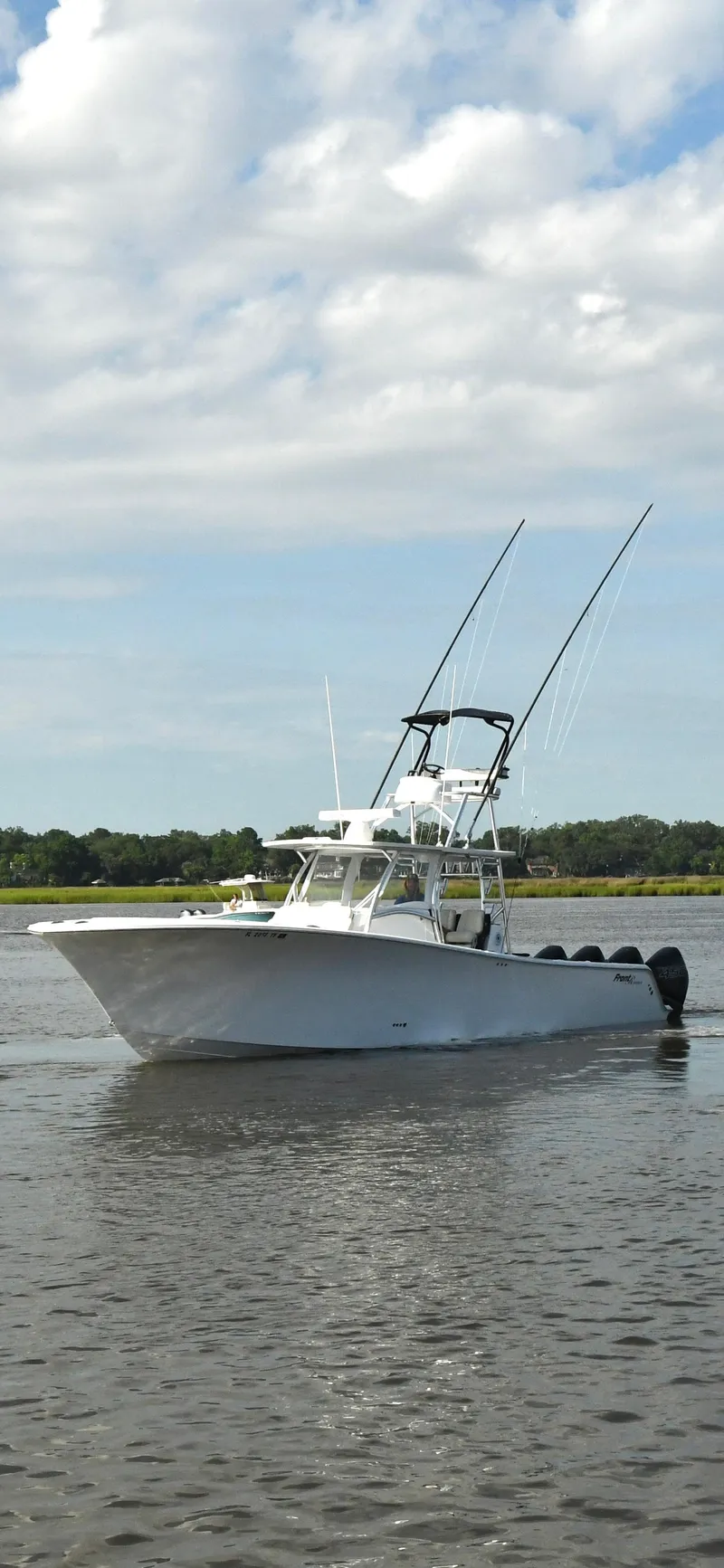 Slide: The Image of 2022 Front Runner 39 Center Console boat on calm water under a cloudy sky. - 3