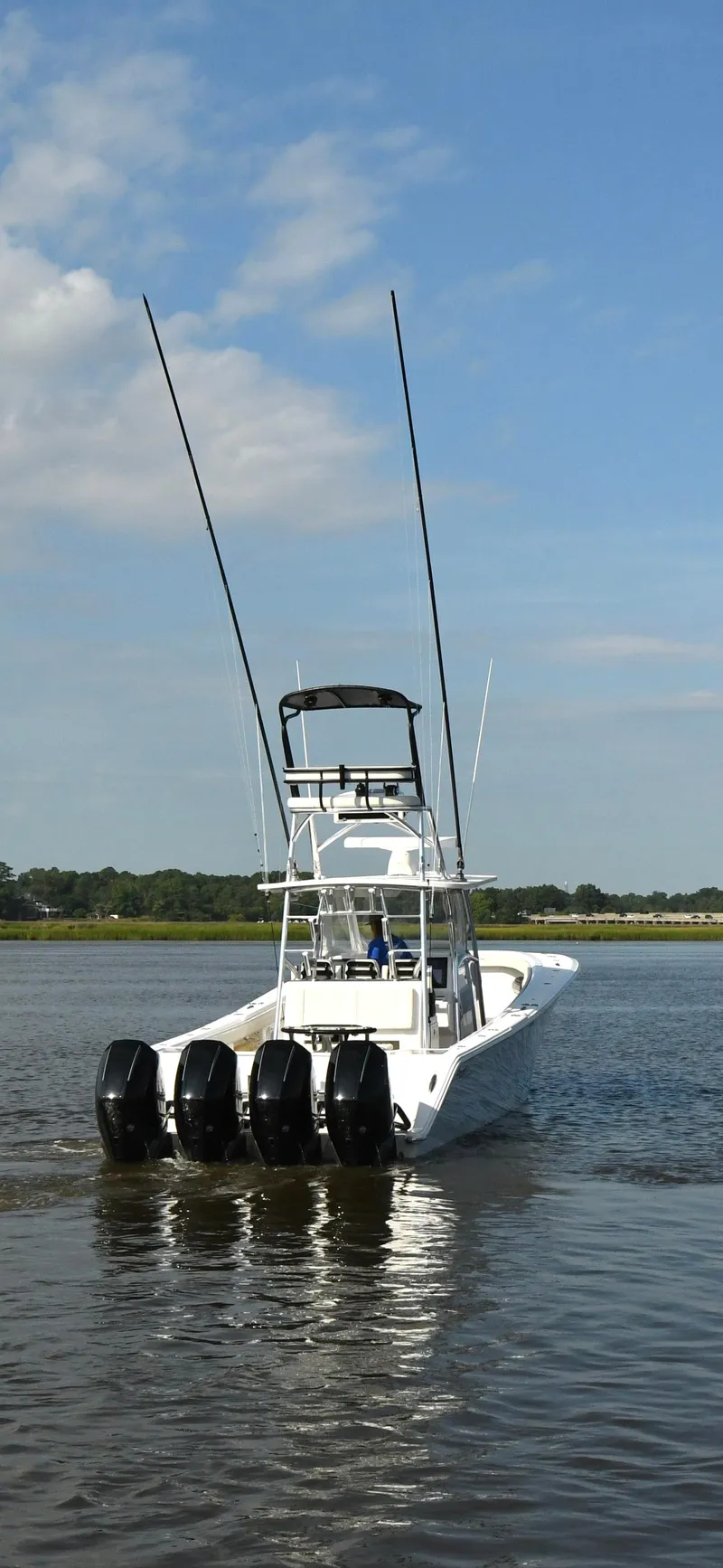 Slide: The Image of 2022 Front Runner 39 Center Console boat with four engines on calm water. - 4