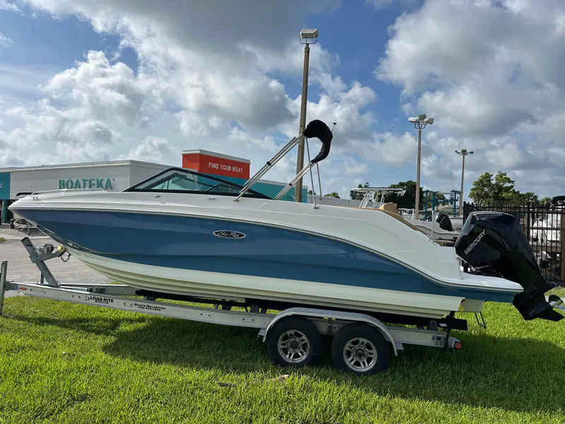 Slide: The Image of 2023 Sea Ray SDX 250 Outboard boat on trailer, displayed outdoors under cloudy sky. - 3