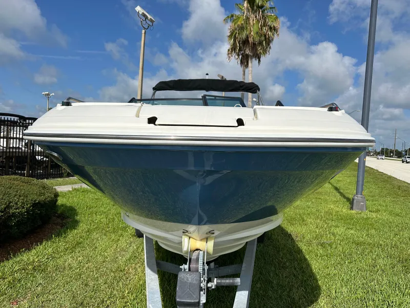 Slide: The Image of 2023 Sea Ray SDX 250 Outboard boat on trailer, parked on grass under blue sky. - 4