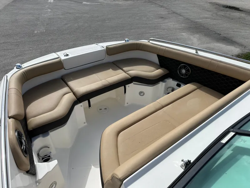 Slide: The Image of 2023 Sea Ray SDX 250 Outboard boat interior with beige seating and speaker system. - 8