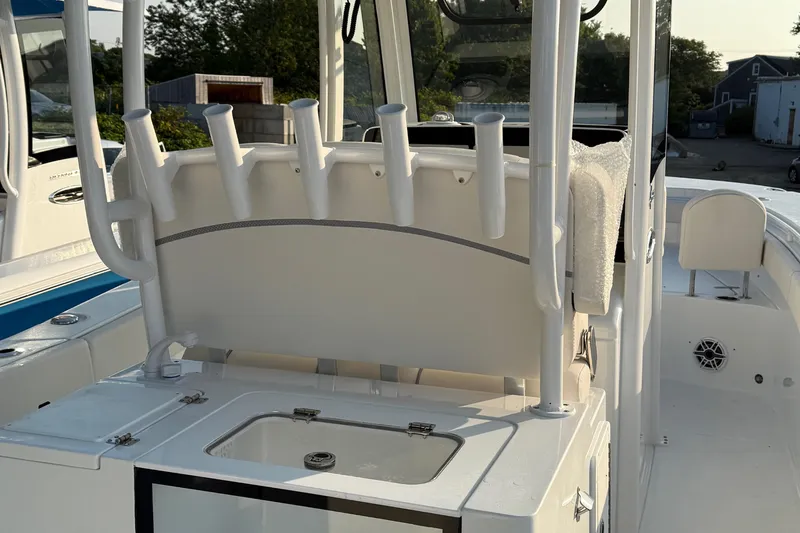 Slide: The Image of 2026 Sea Hunt Gamefish 28 boat interior with rod holders and storage compartment. - 2