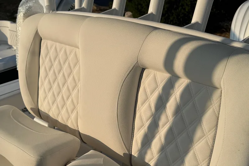 Slide: The Image of 2026 Sea Hunt Gamefish 28 boat seat with beige diamond-stitched upholstery. - 5