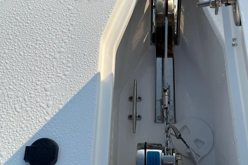 Slide: The Image of Anchor compartment of 2026 Sea Hunt Gamefish 28 boat, featuring chain and cleat. - 6