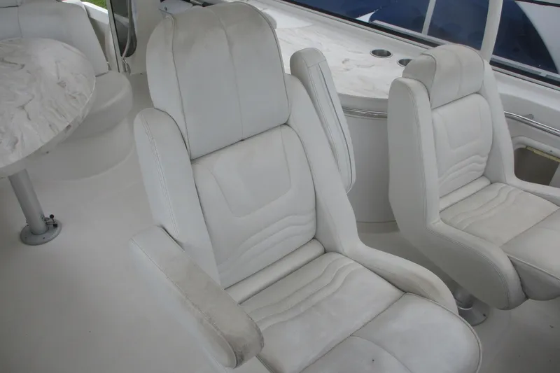 Slide: The Image of Interior of 2006 Carver 466 Motor Yacht with white seating and table. - 16