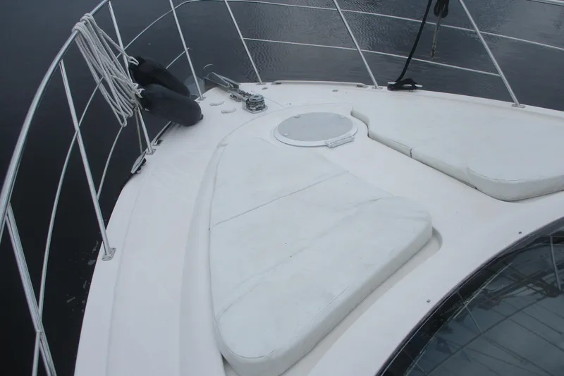 Slide: The Image of 2006 Carver 466 Motor Yacht bow with white cushions and railing. - 19