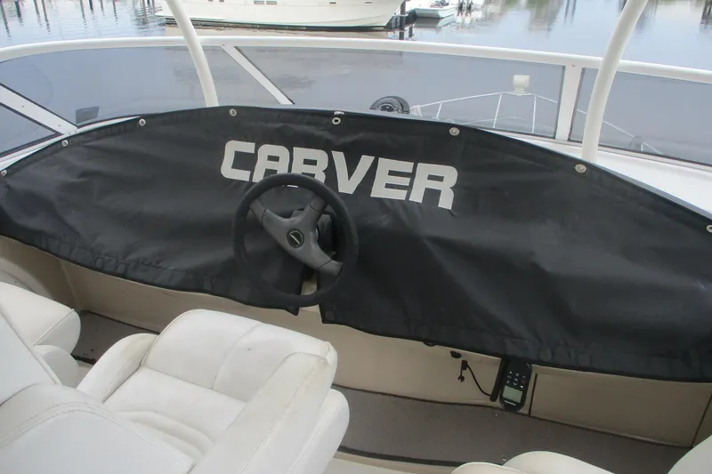 Slide: The Image of 2006 Carver 466 Motor Yacht helm with protective cover and steering wheel. - 3