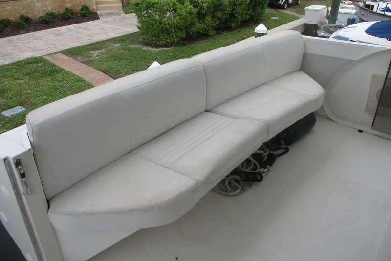 Slide: The Image of White seating area on 2006 Carver 466 Motor Yacht deck, with ropes underneath. - 30