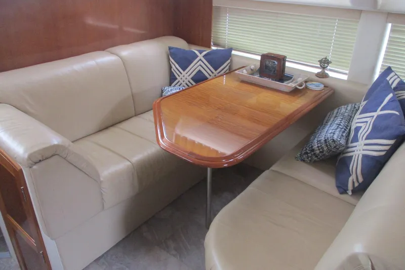 Slide: The Image of Interior of 2006 Carver 466 Motor Yacht with beige seating and wooden table. - 44