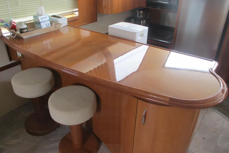 Slide: The Image of Interior of 2006 Carver 466 Motor Yacht with polished wooden bar and stools. - 45