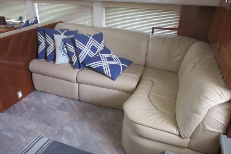 Slide: The Image of Luxurious beige leather sofa with blue patterned pillows in 2006 Carver 466 Motor Yacht. - 47