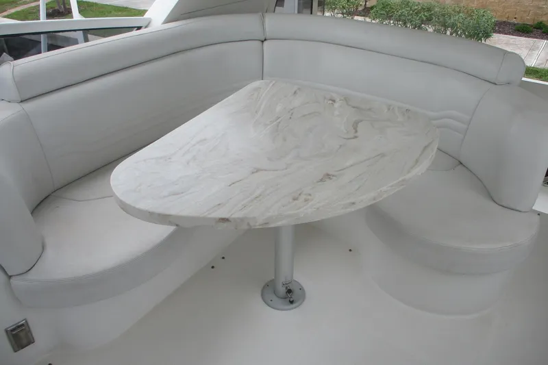 Slide: The Image of 2006 Carver 466 Motor Yacht interior with elegant marble table and plush seating. - 5