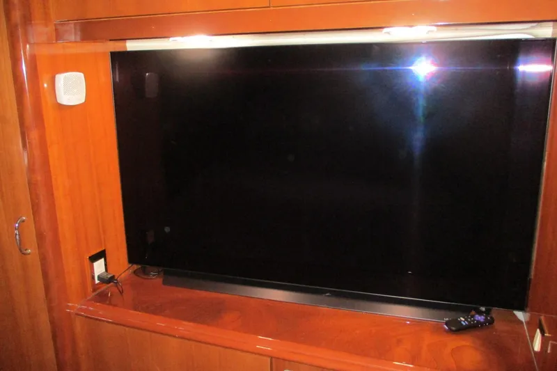 Slide: The Image of Flat-screen TV in 2006 Carver 466 Motor Yacht's wooden interior entertainment area. - 52