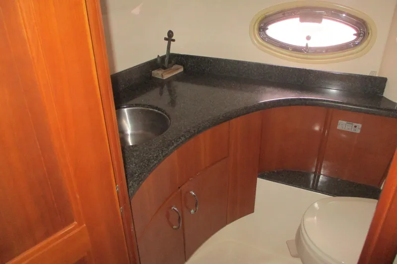 Slide: The Image of Luxurious bathroom in 2006 Carver 466 Motor Yacht with granite countertop and porthole window. - 54