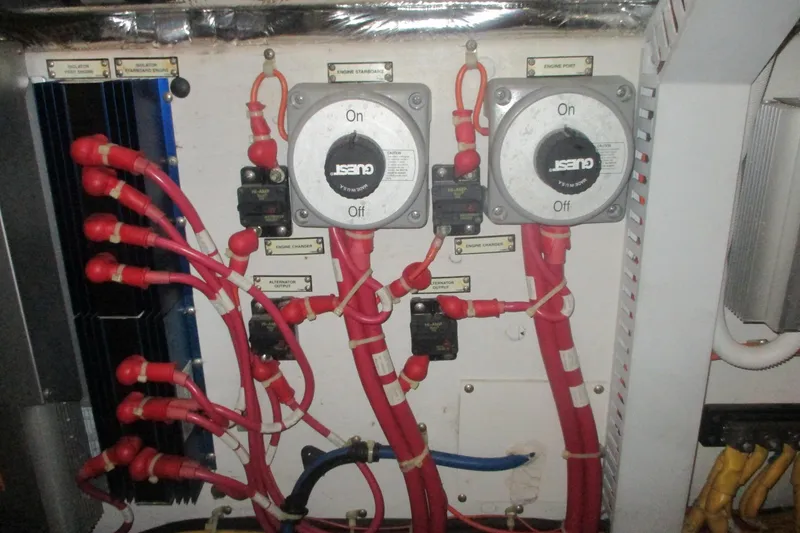Slide: The Image of Electrical panel with red cables on a 2006 Carver 466 Motor Yacht. - 58