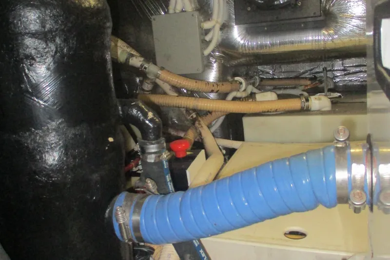 Slide: The Image of Engine room of 2006 Carver 466 Motor Yacht with hoses and fittings. - 61