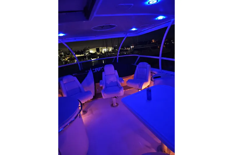 Slide: The Image of 2006 Carver 466 Motor Yacht interior with blue ambient lighting at night. - 68