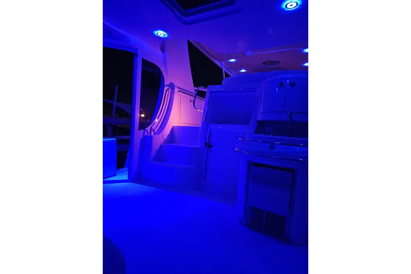 Slide: The Image of 2006 Carver 466 Motor Yacht interior with blue LED lighting at night. - 70