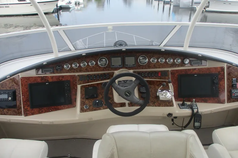 Slide: The Image of 2006 Carver 466 Motor Yacht helm with advanced navigation controls and luxurious design. - 9