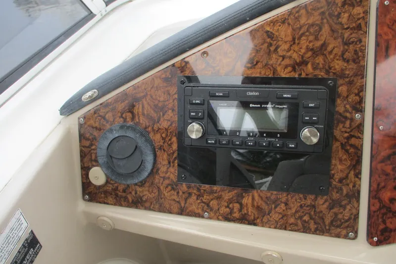 Slide: The Image of 2006 Carver 466 Motor Yacht dashboard with Clarion audio system and wood paneling. - 11