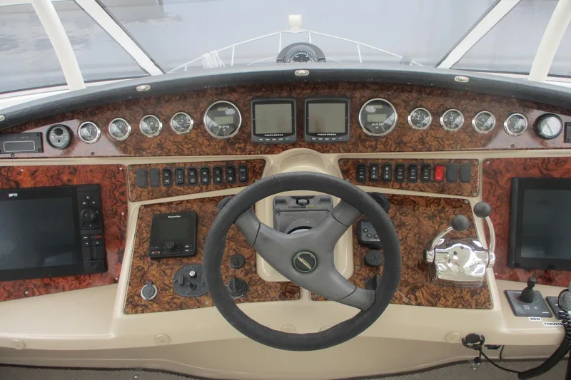 Slide: The Image of 2006 Carver 466 Motor Yacht helm with advanced navigation controls and instruments. - 13