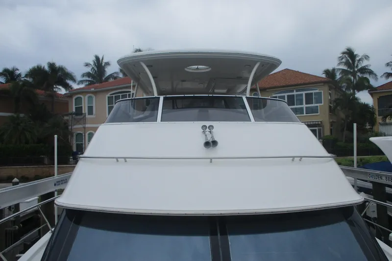 Slide: The Image of 2006 Carver 466 Motor Yacht docked near waterfront homes, showcasing sleek design. - 22