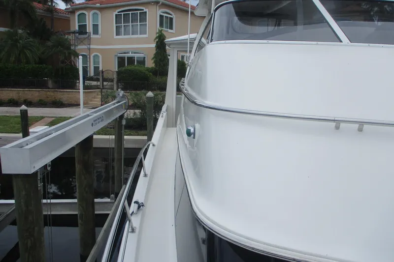 Slide: The Image of 2006 Carver 466 Motor Yacht docked near waterfront homes. - 24