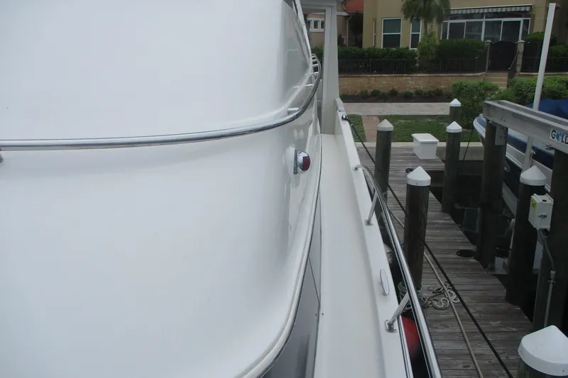 Slide: The Image of 2006 Carver 466 Motor Yacht docked, showcasing sleek white exterior and polished railings. - 25