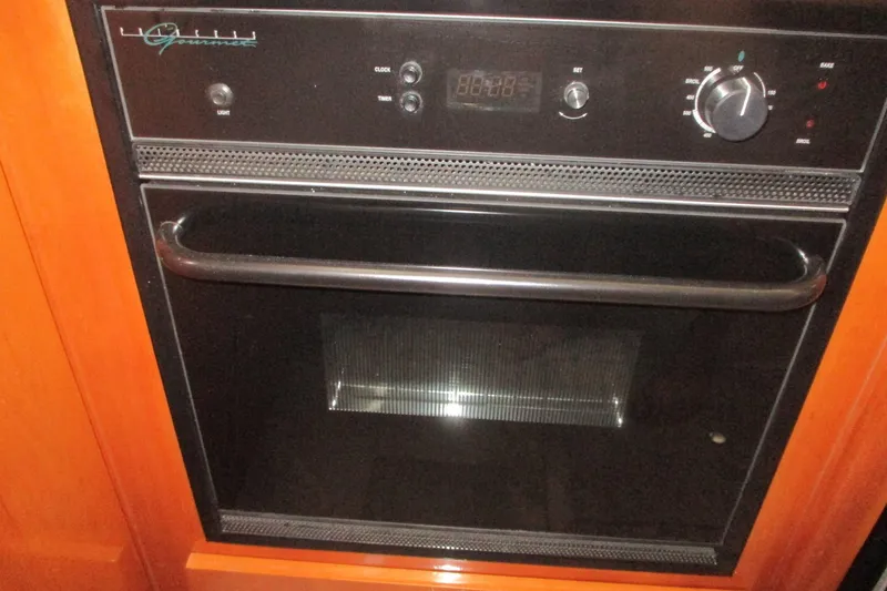 Slide: The Image of Built-in oven on 2006 Carver 466 Motor Yacht, featuring control knobs and digital display. - 42
