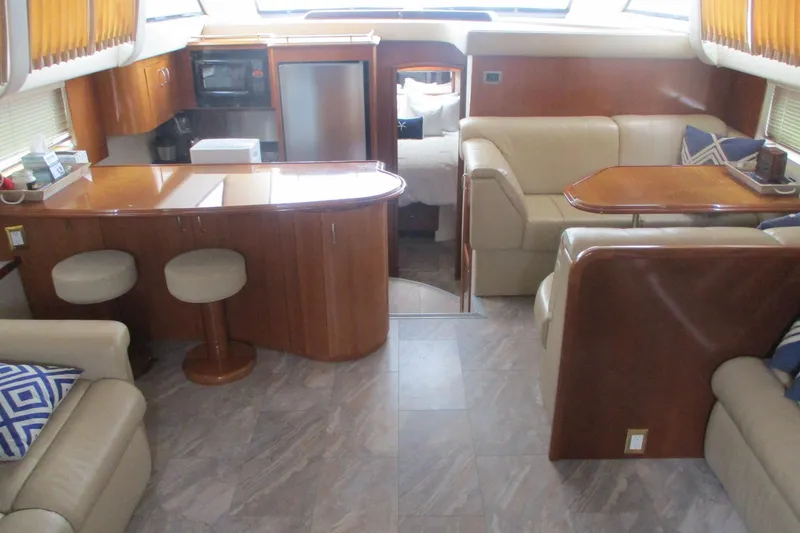 Slide: The Image of Luxurious interior of 2006 Carver 466 Motor Yacht with elegant seating and dining area. - 48