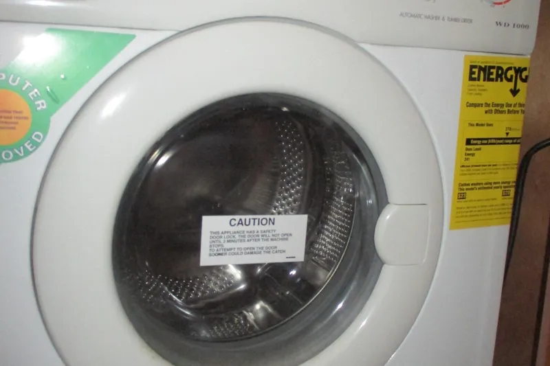 Slide: The Image of Front-loading washing machine with caution label and energy efficiency sticker. - 50