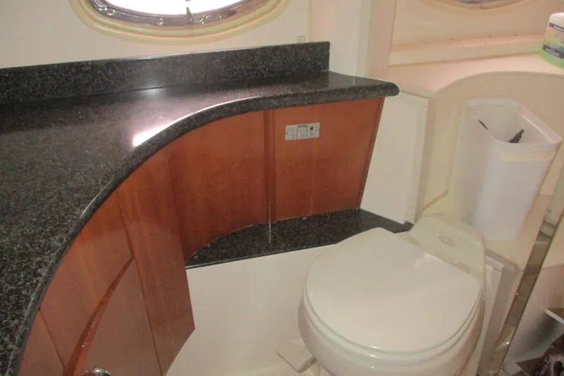 Slide: The Image of 2006 Carver 466 Motor Yacht bathroom with granite countertop and modern fixtures. - 55