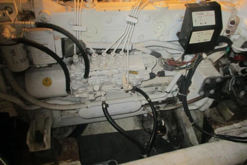 Slide: The Image of Engine compartment of a 2006 Carver 466 Motor Yacht, showcasing mechanical components and wiring. - 57