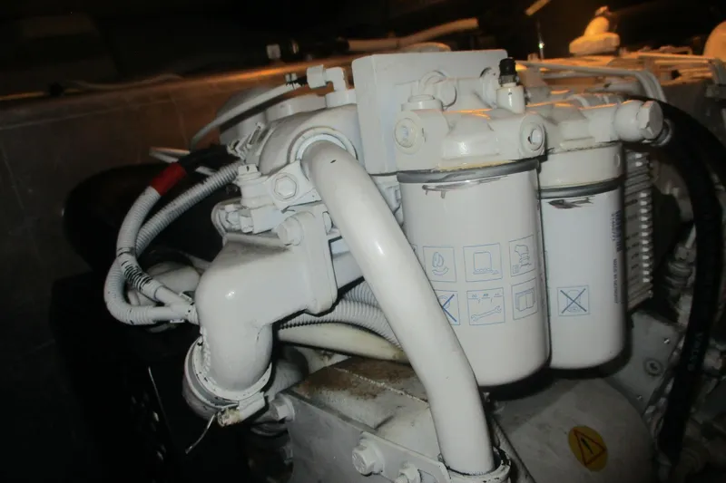 Slide: The Image of Engine components of a 2006 Carver 466 Motor Yacht, featuring filters and hoses. - 65
