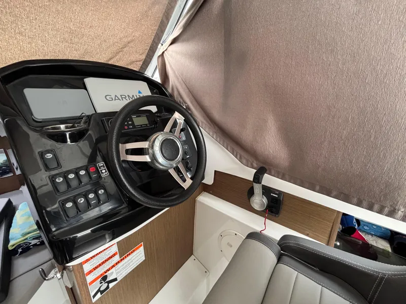 Slide: The Image of 2019 Jeanneau NC 795 boat cockpit with Garmin navigation system and steering wheel. - 14