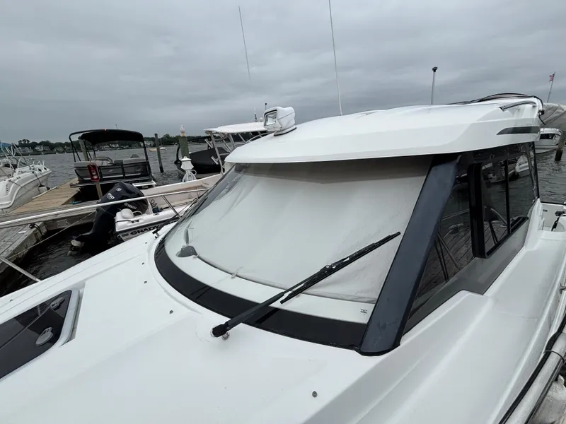 Slide: The Image of 2019 Jeanneau NC 795 boat docked at marina on cloudy day. - 4