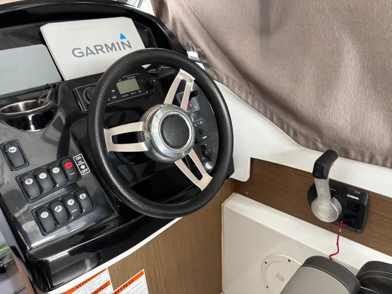 Slide: The Image of Steering wheel and controls of a 2019 Jeanneau NC 795 boat with Garmin system. - 6