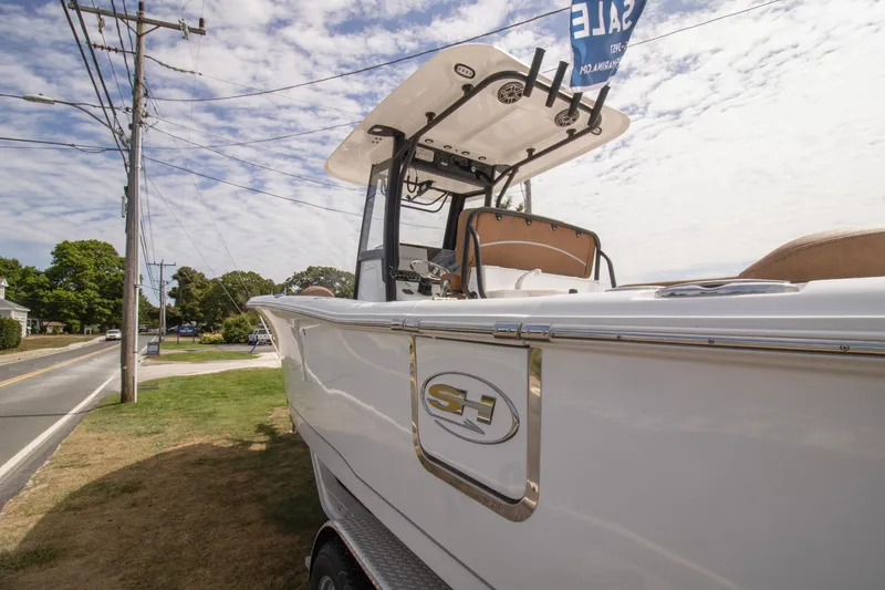 The Image of 2026 Sea Hunt Ultra 265 SE boat displayed for sale on a grassy roadside. - 0