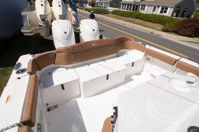 Slide: The Image of 2026 Sea Hunt Ultra 265 SE boat interior with tan seating and dual engines. - 10