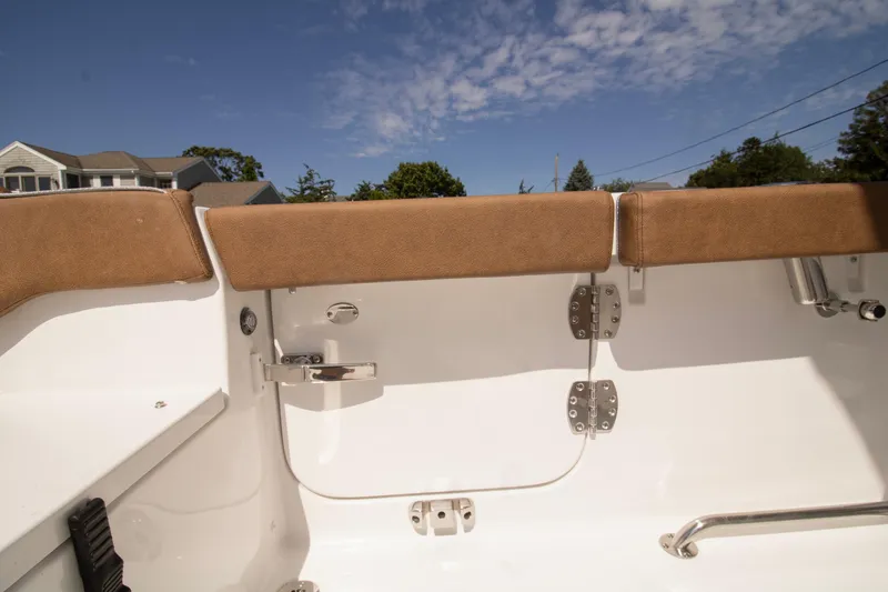 Slide: The Image of 2026 Sea Hunt Ultra 265 SE boat interior with tan seating and stainless steel fittings. - 11