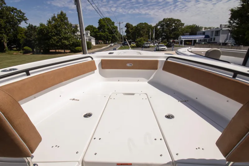 Slide: The Image of 2026 Sea Hunt Ultra 265 SE boat interior with cushioned seating and open deck. - 2