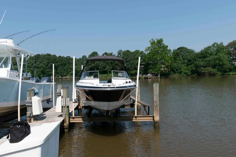 Slide: The Image of 2006 Formula 240 Bowrider boat docked on a sunny day by a serene lake. - 19