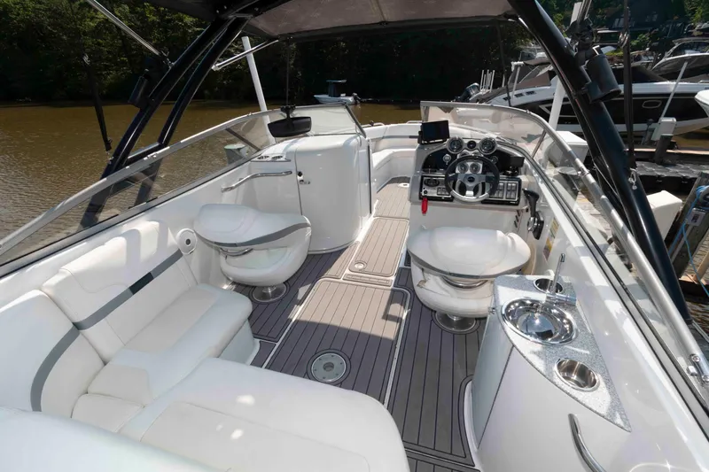 Slide: The Image of 2006 Formula 240 Bowrider boat interior with white seating and modern dashboard controls. - 21