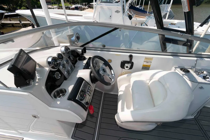 Slide: The Image of 2006 Formula 240 Bowrider cockpit with steering wheel, gauges, and white captain's seat. - 23