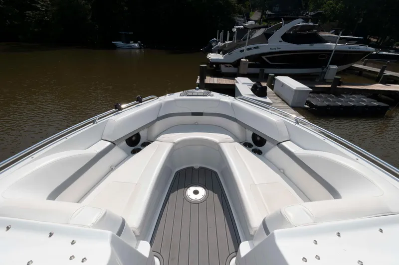 Slide: The Image of 2006 Formula 240 Bowrider boat with spacious seating, docked by the water. - 26