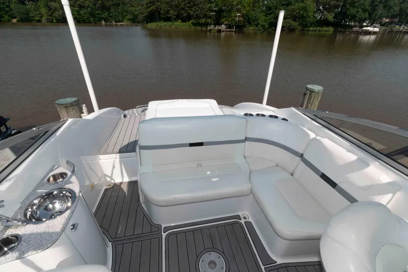Slide: The Image of 2006 Formula 240 Bowrider boat interior with white seating and lake view. - 27